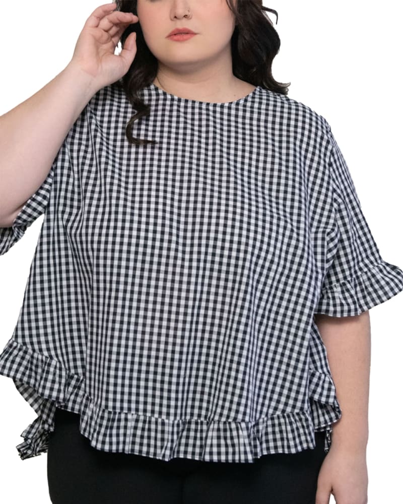 Front of a model wearing a size 1X Dominique Blouse Gingham Frills Hi-Low in Black by ANNICK. | dia_product_style_image_id:282067